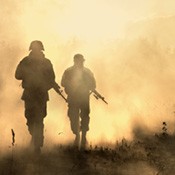 Soldiers walking through a dust cloud